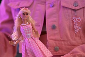 A moviegoer in a pink denim jacket holds a Barbie doll after watching the "Barbie" film in Quezon City, Philippines on July 19, 2023.