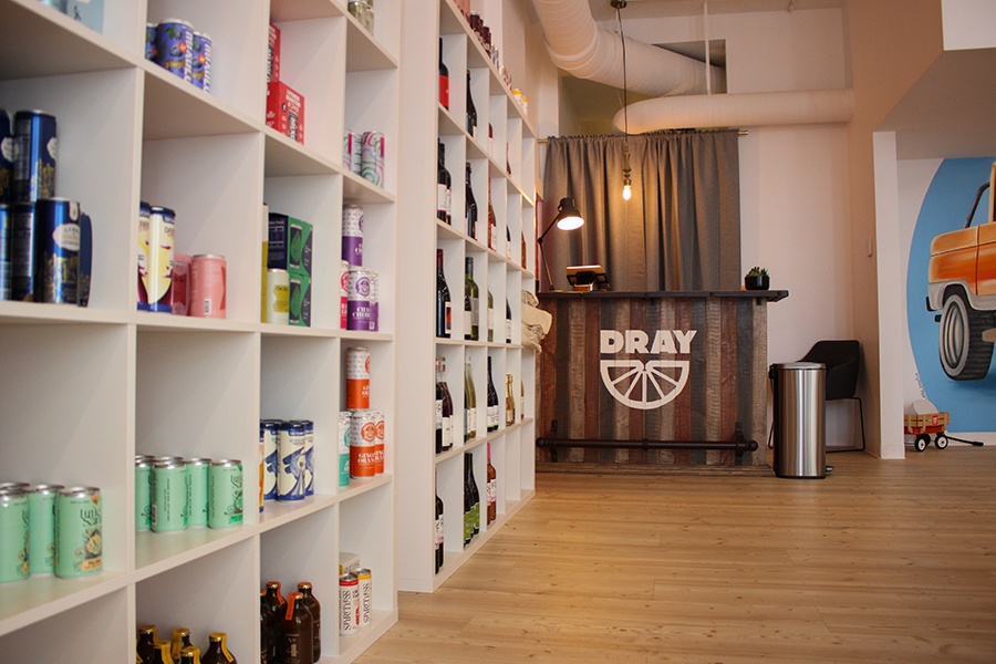 Shelves of bottles and cans line a nonalcoholic bottle shop.