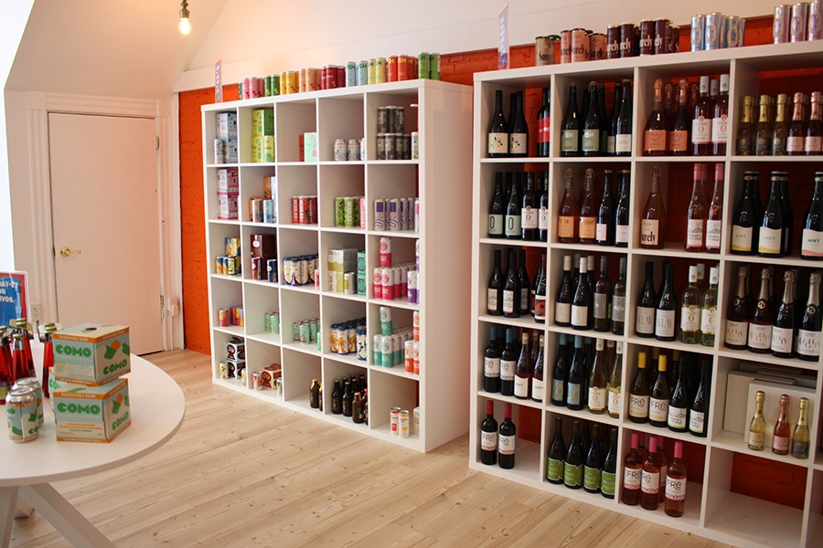Shelves of bottles and cans line a nonalcoholic bottle shop.