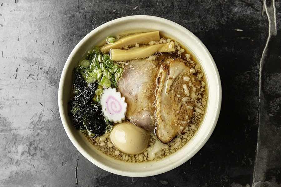 Overhead view of a bowl of porky ramen with an egg.