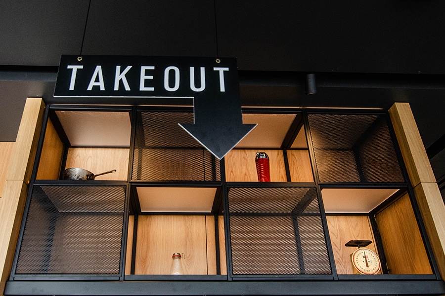 An arrow-shaped sign says takeout.