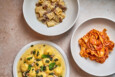 Overhead view of three different pasta dishes.