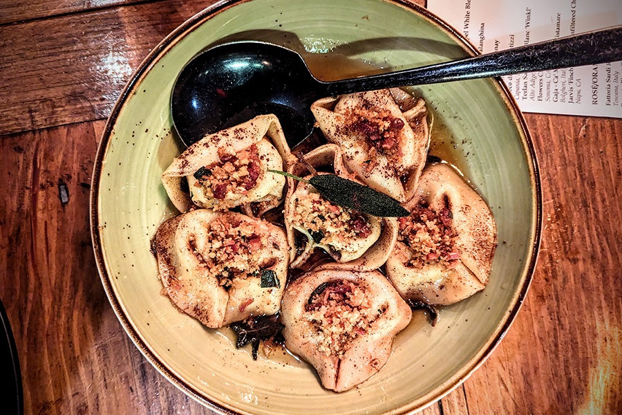 Overhead view of plump Italian tortellacci with a crumble of panko.