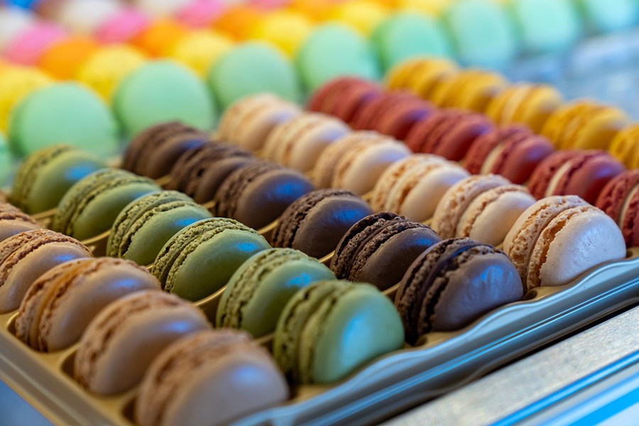 Rows of colorful macarons on display.