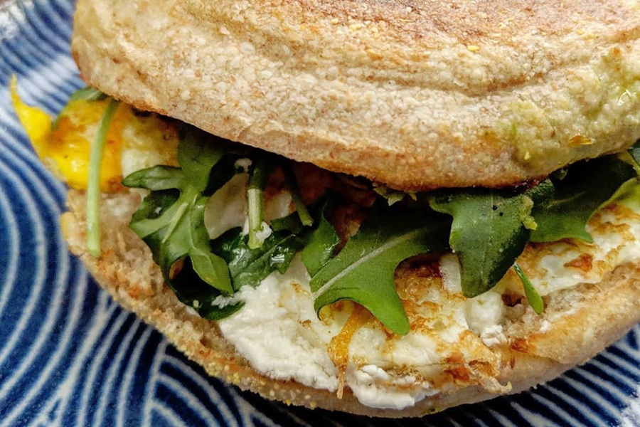 Arugula, eggs, and more on an English muffin.