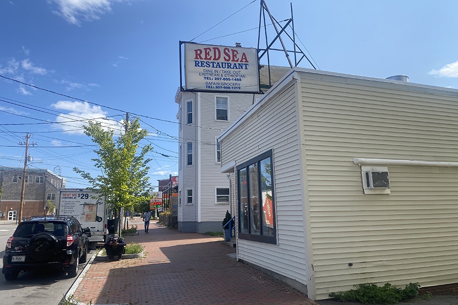 A small, single-story building has signage for Red Sea Restaurant, Eritrean and Ethiopian food.