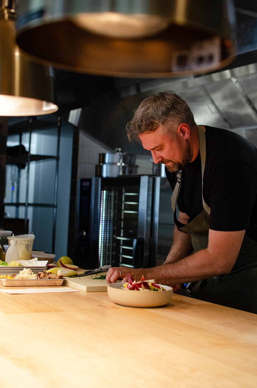 A chef works in the kitchen at a restaurant.