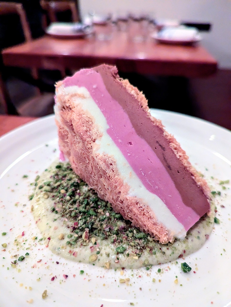 A triangular sandwich of three ice cream flavors with crunchy kataifi on the outside.