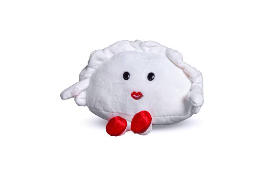 A plushie is shaped like a dumpling with a face, arms, legs, and red shoes.