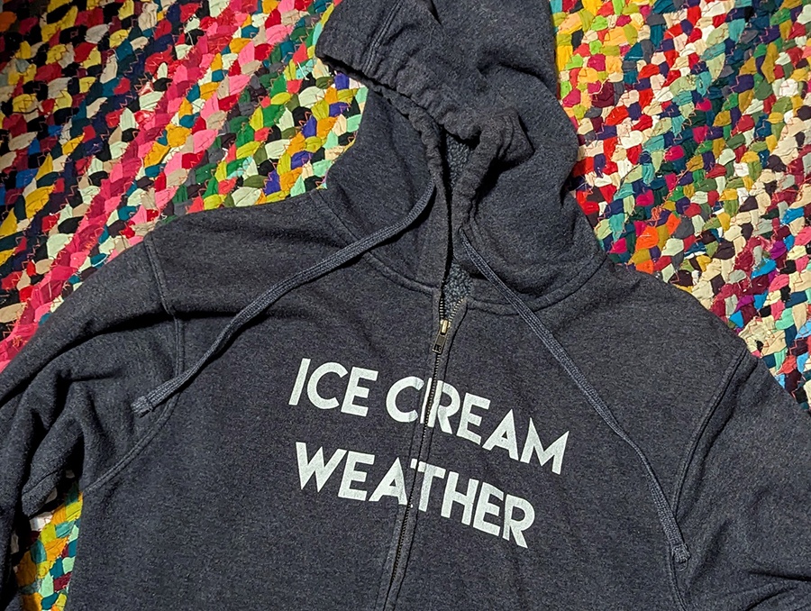 A dark gray hoodie reads "ice cream weather" in white caps.