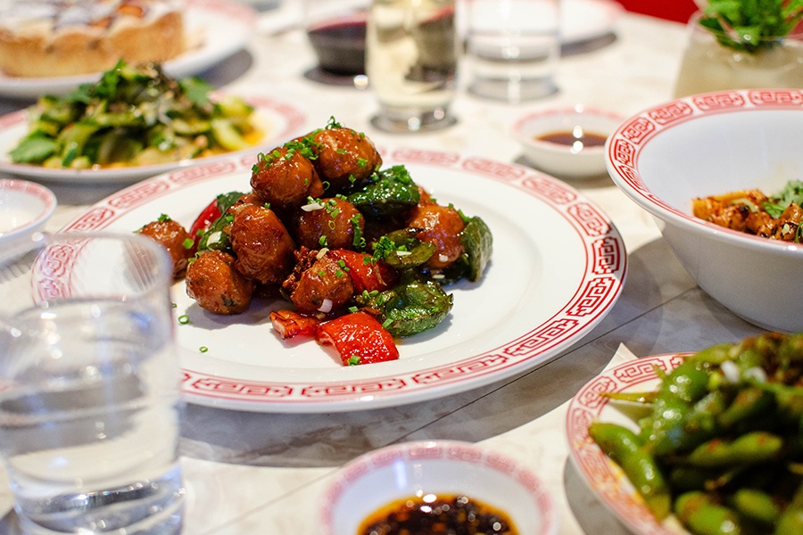 Small, saucy meatballs are tossed with red and green pepper slices.