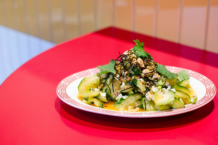 A cucumber salad with peanuts, seaweed, and other garnishes.