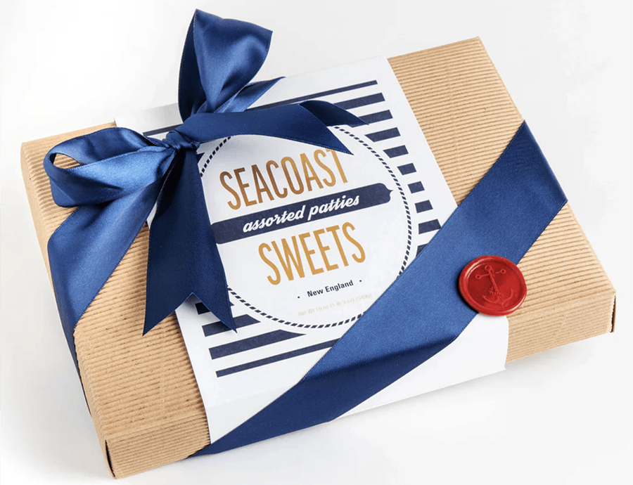 A box wrapped in a blue ribbon has a label reading Seacoast Sweets: Assorted Patties.