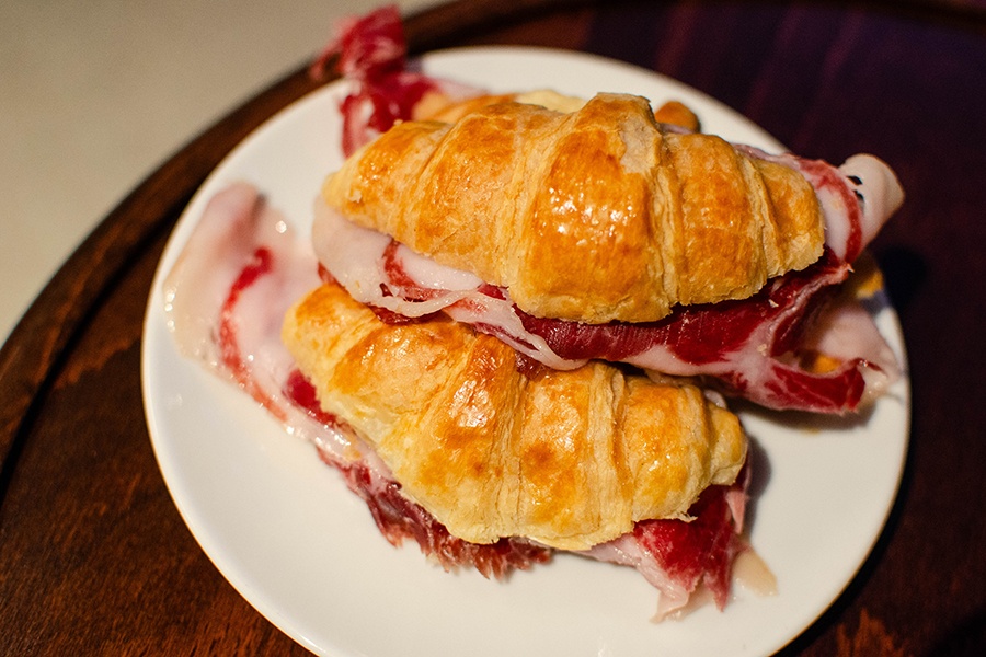 Croissants are stuffed with slices of ham.