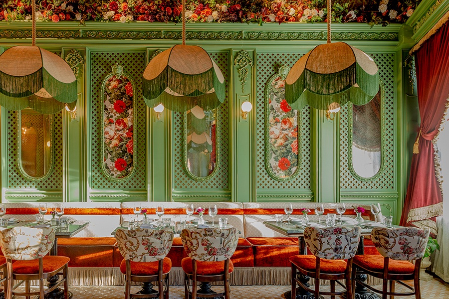 An ornately decorated restaurant interior with greens, reds, and lots of floral accents.