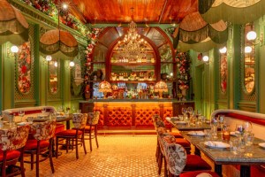 An ornately decorated restaurant interior with greens, reds, and lots of floral accents.