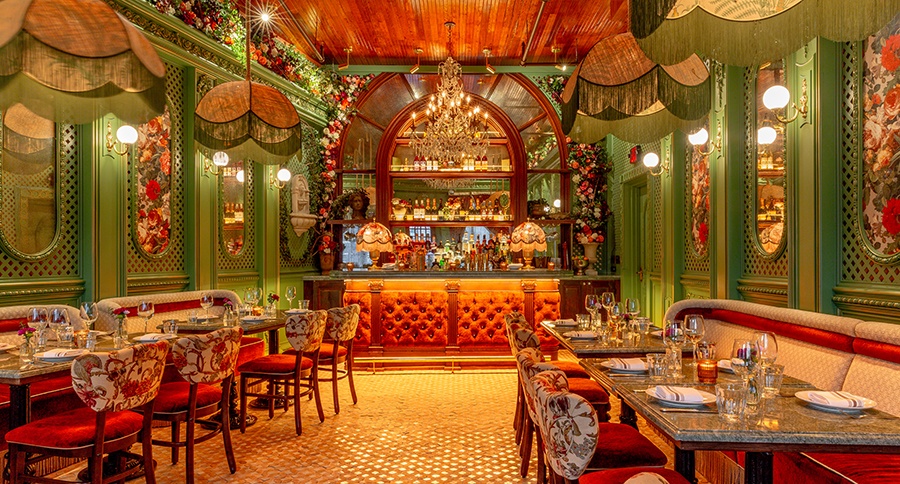 An ornately decorated restaurant interior with greens, reds, and lots of floral accents.