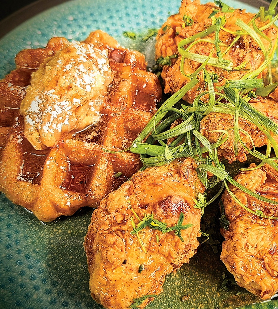 Crispy chicken and waffles, topped with scallions.