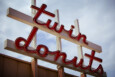 Vintage-looking neon signage reads "twin donuts" in lowercase cursive red letters.