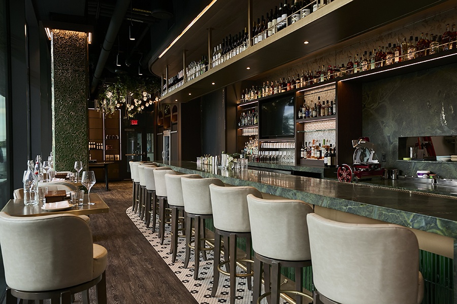 An interior restaurant photo includes a dark green marble bar and upscale-looking lounge seating.